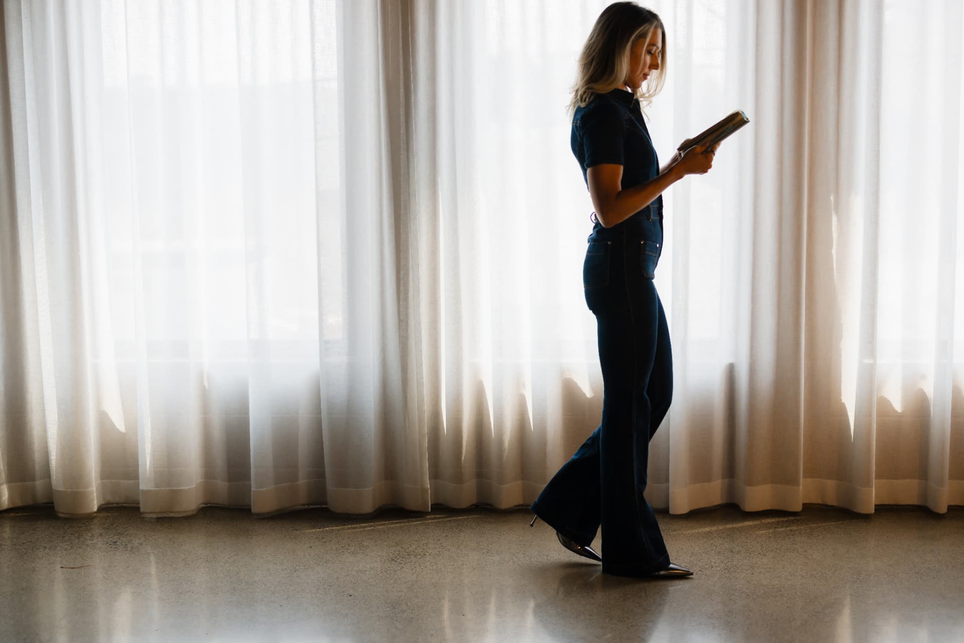 Mandy Balak reading in front of a window