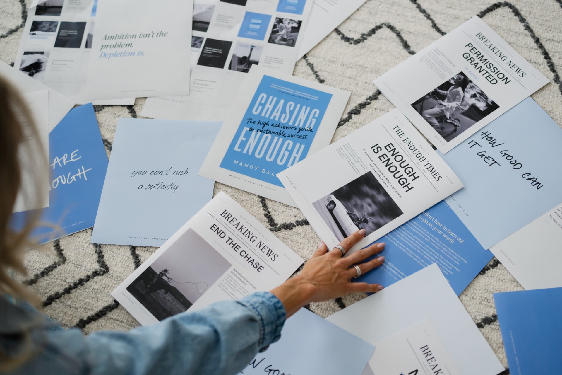 Chasing Enough proof copy and printed pages laid out on a rug